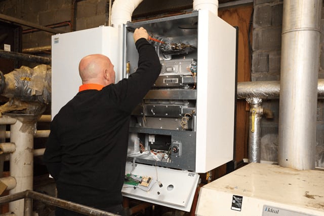 Image of a member from the Eric Collier & Son team carrying out boiler repair in Cardiff
