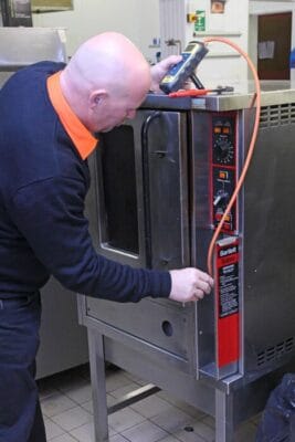 Image of an Eric Collier engineer carrying out a catering maintenance service