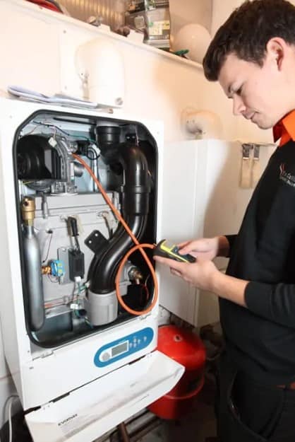 Heating engineer carrying out a boiler service on a boiler system for a business in Newport